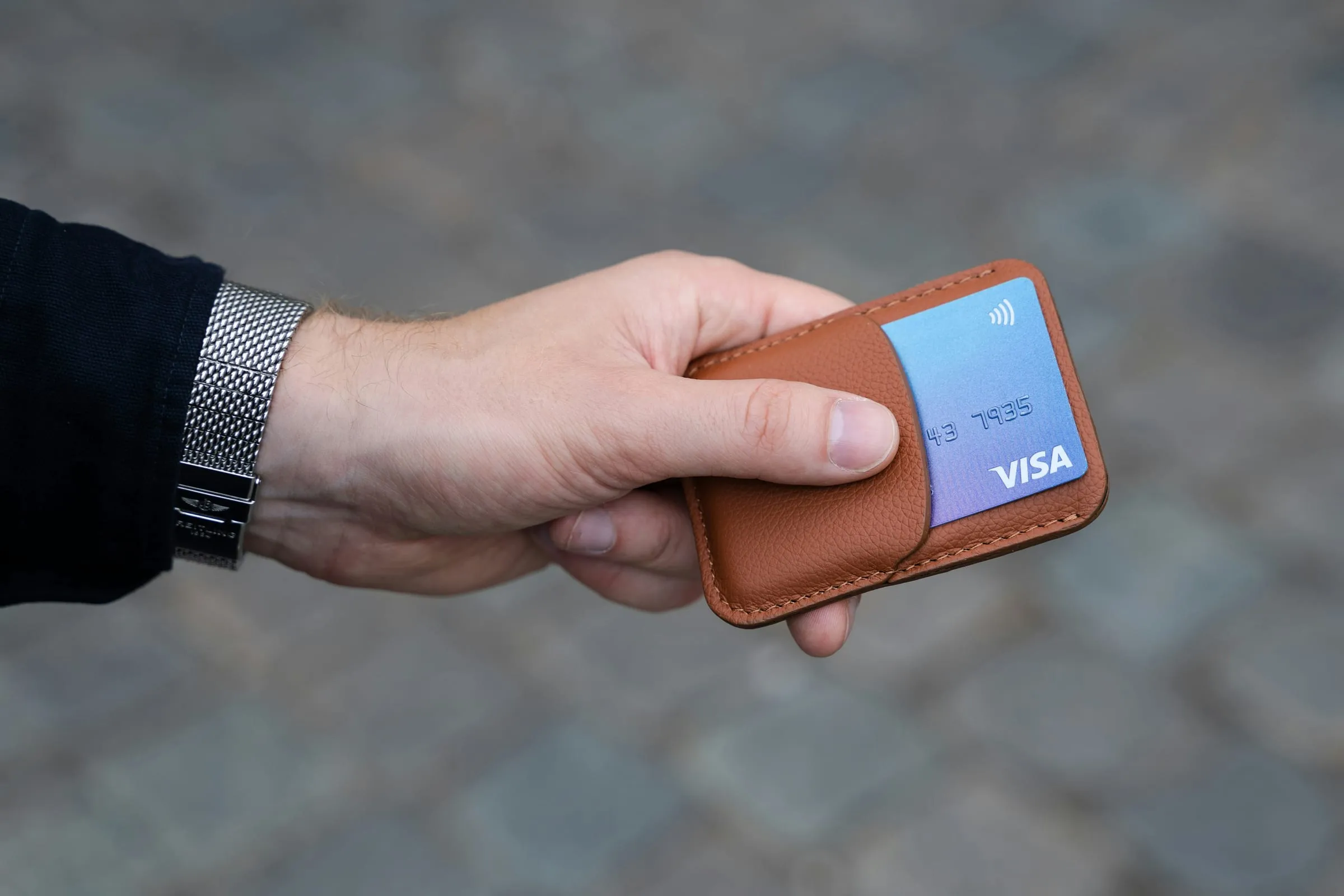 A credit card being swiped through a reader