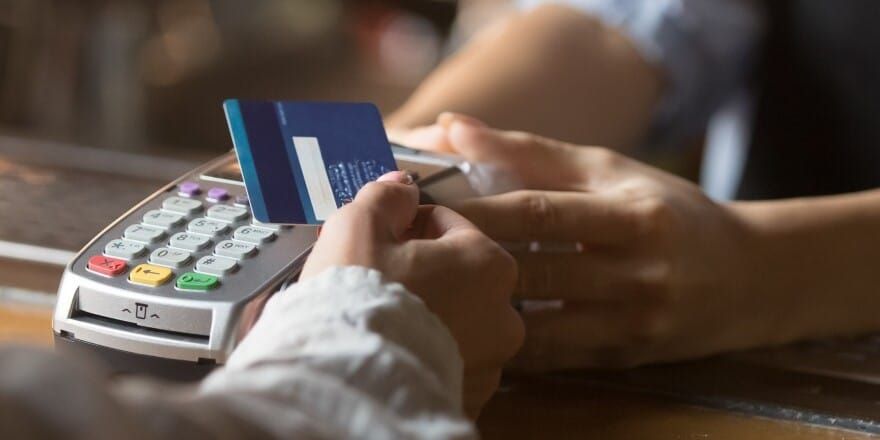 Customer inserting a credit card into a countertop card terminal