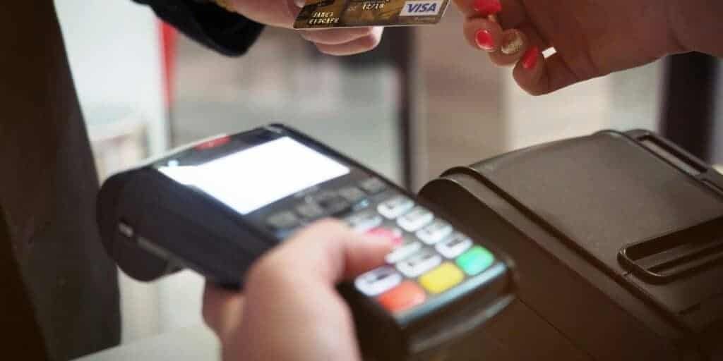 Customer entering a PIN on a handheld card terminal